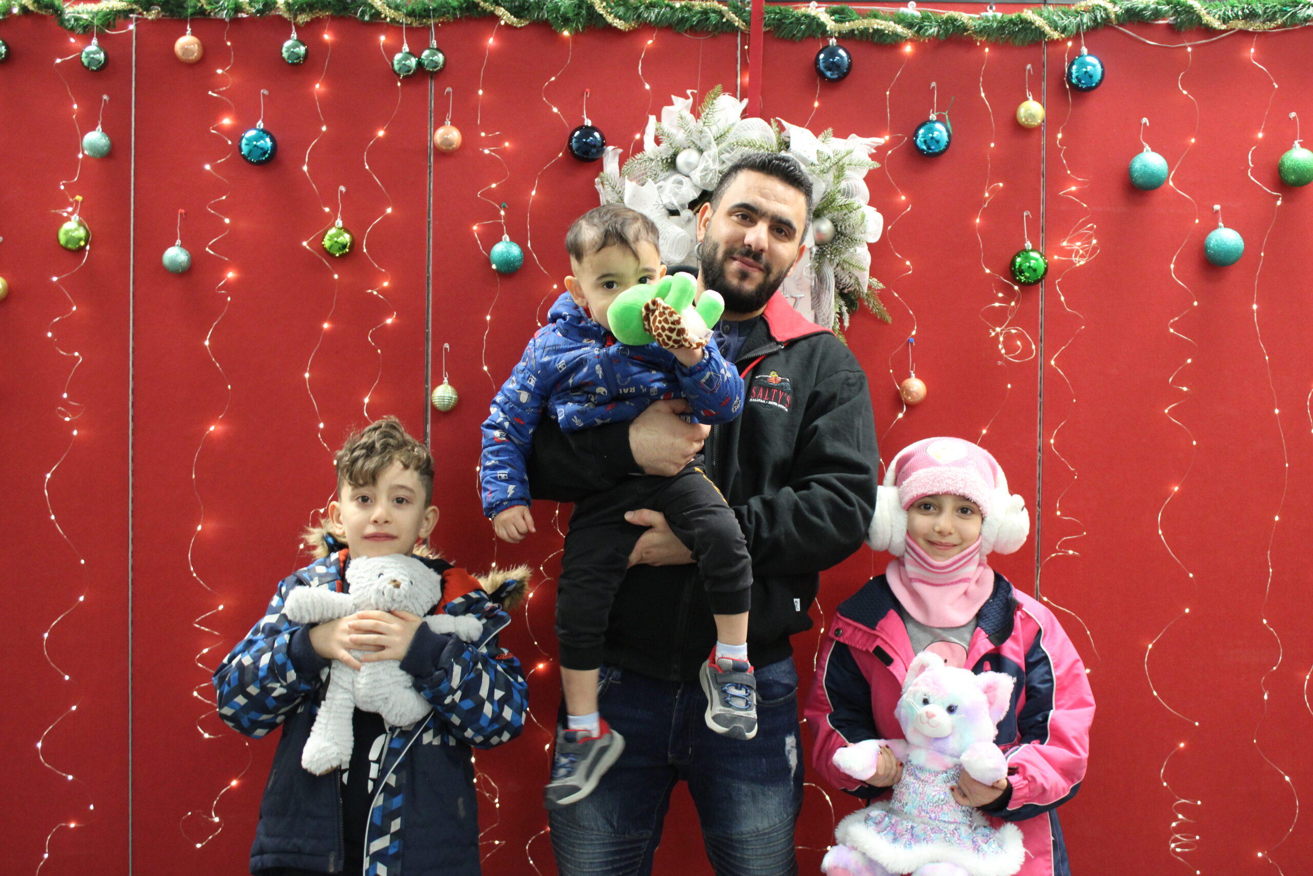 A program participant and sponsor at New Circles with Holiday gifts