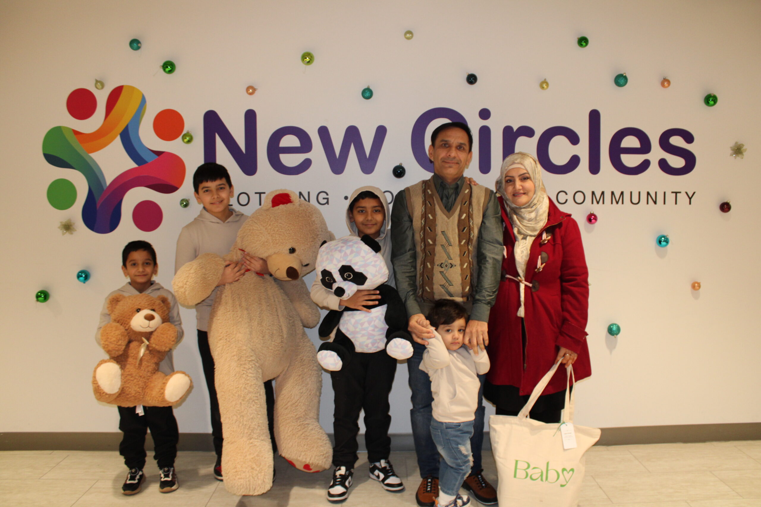 A program participant and sponsor at New Circles with Holiday gifts